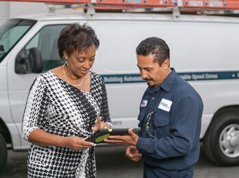 Male maintenance technician discussing a project with the client