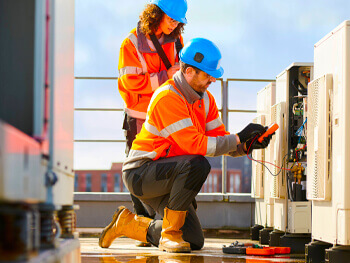 Two HVAC Technicians working on maintenance at a client facility