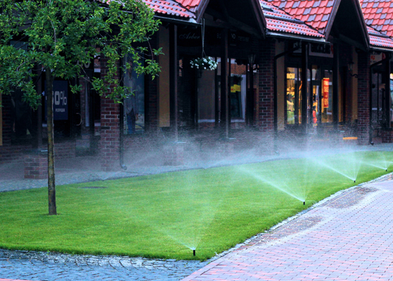 Water irrigation system watering the gradd at a commercial facility