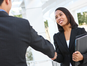 Business man shaking a business women's hand