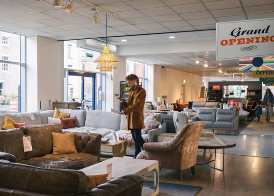 Furniture showroom with Grand Opening sign hanging from ceiling