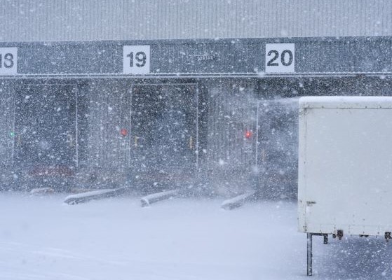 View of a loading dock at the back of a building on a very snowy day